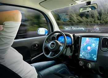 A man in the driver's seat of a car, using a dashboard for navigation and control - Sharks at Law