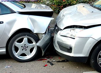 Two damaged cars after a collision on the road - Sharks at Law