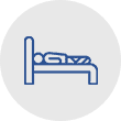 A blue icon depicting a person lying in bed, representing wrongful death - Sharks At Law