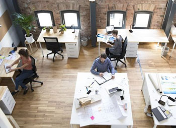 An overhead view of people in office space - Sharks at Law