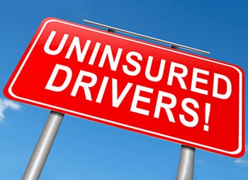 Warning sign for uninsured drivers, emphasizing the importance of having insurance - Sharks at Law