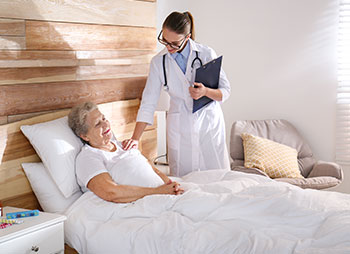 Attorney Alexander Memmen supporting injury recovery – doctor visiting senior patient in modern hospital